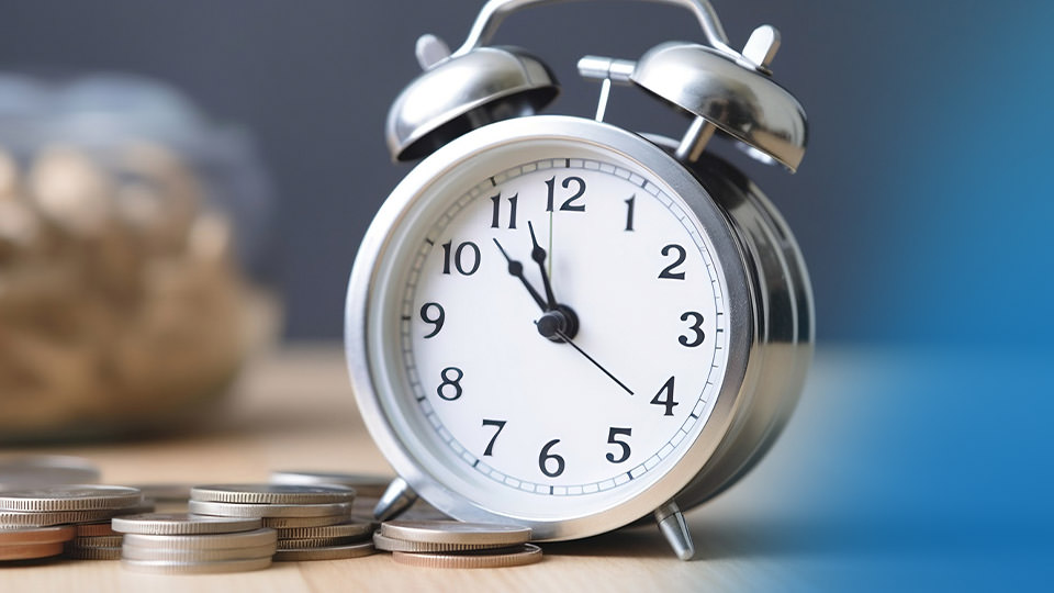An old fashioned alarm clock sitting on a table
